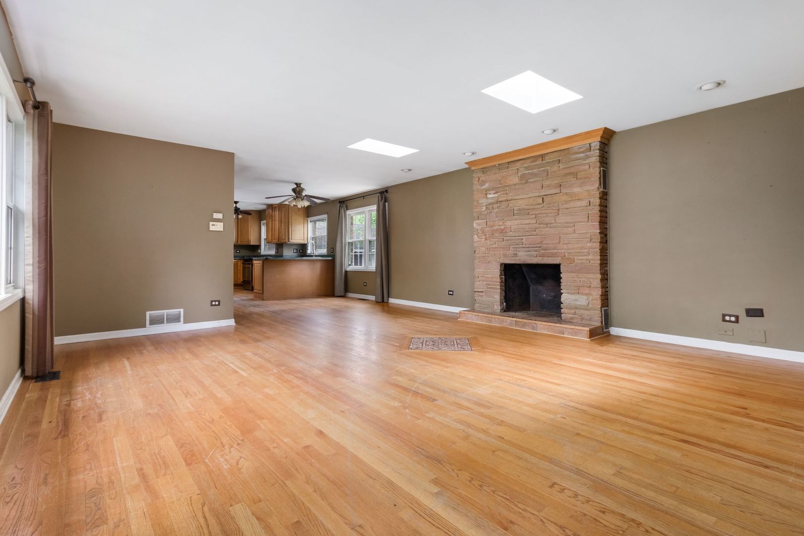 N659 Old Kirk Road West Chicago, IL 60185 - Photo 7 of 24 a view of empty room with wooden floor and fireplace