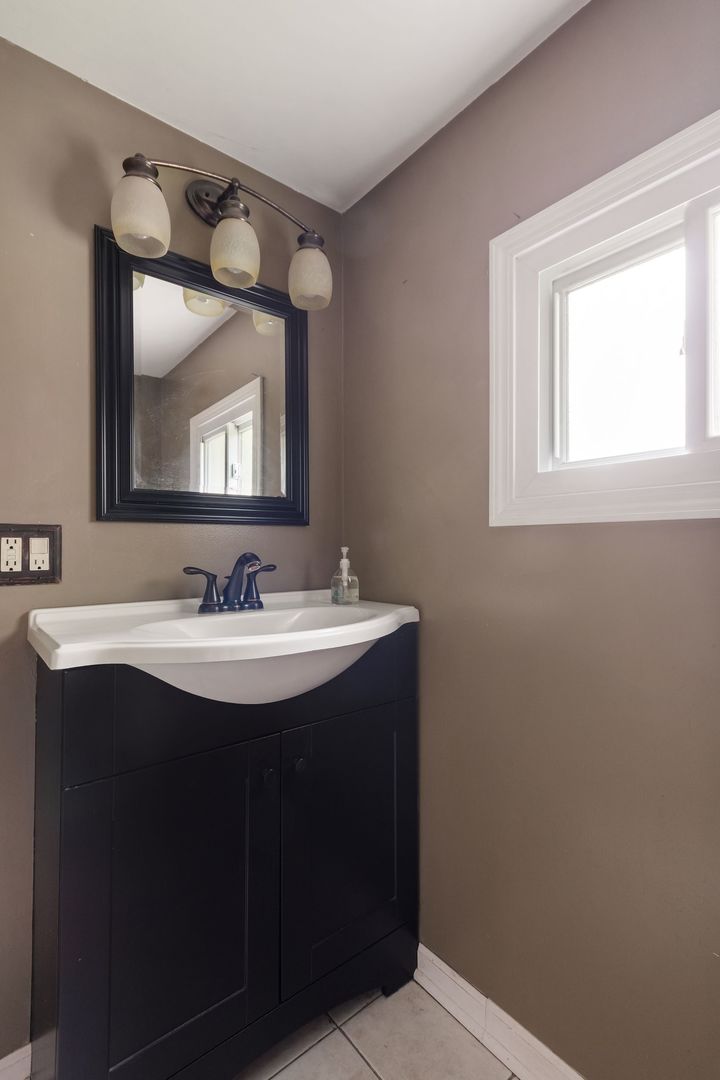 N659 Old Kirk Road West Chicago, IL 60185 - Photo 10 of 24 a bathroom with a sink and a mirror