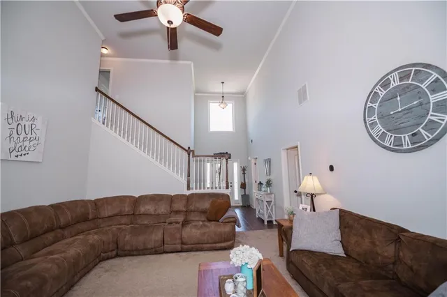 a living room with a couch and a chandelier