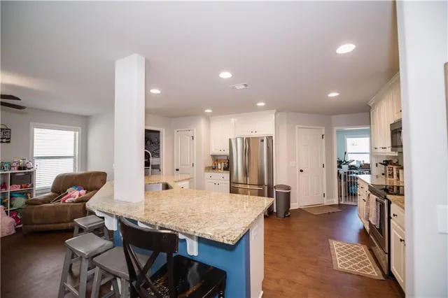 a large kitchen with a table and chairs