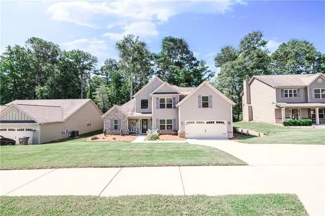 a front view of a house with a yard and garage
