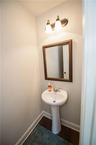 a bathroom with a sink a mirror and toilet