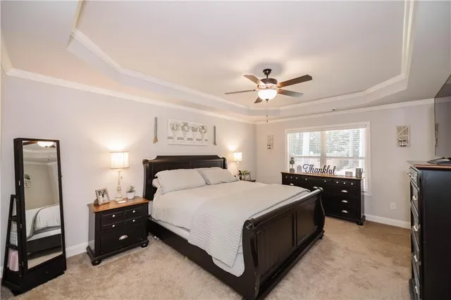 a spacious bedroom with a bed and a chandelier