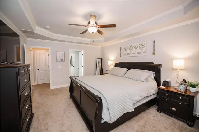 a spacious bedroom with a bed and a chandelier
