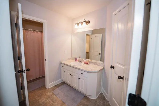 a bathroom with a double vanity sink and a mirror