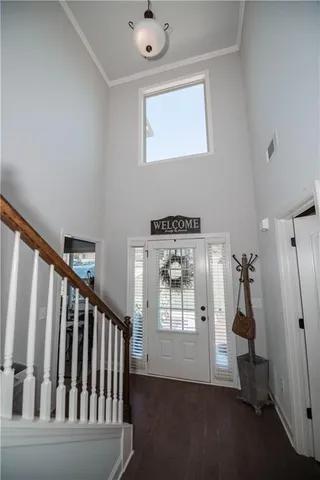 a view of a hallway with windows and entryway