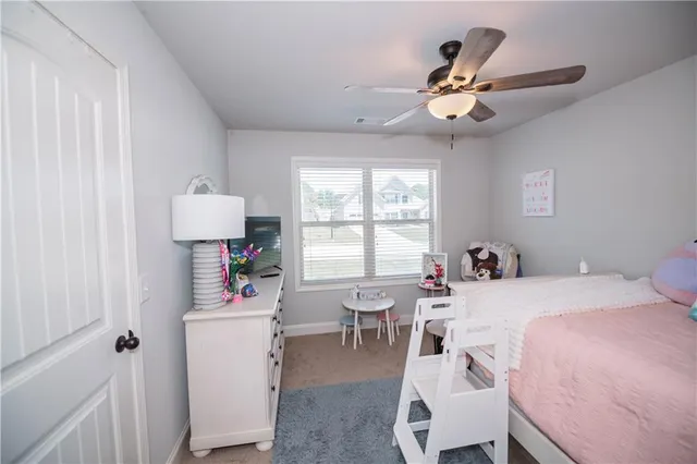 a room that has a bed and a table in it