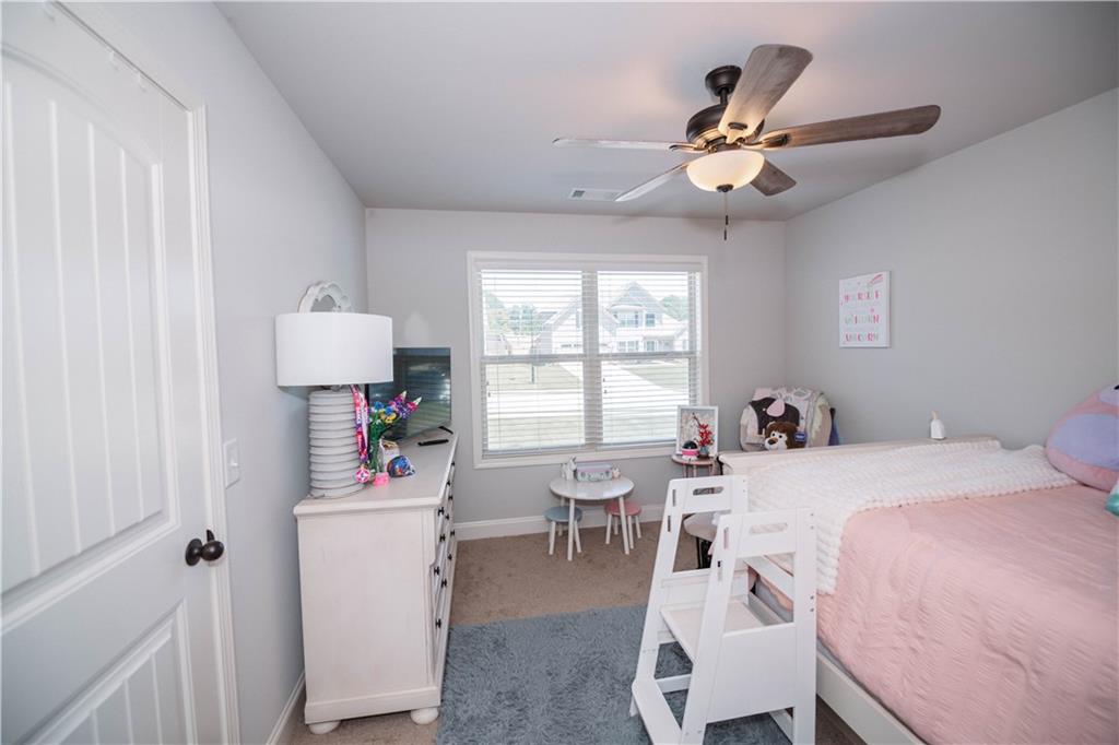 117 Kensington Trace Bethlehem, GA 30620 - Photo 32 of 43 a room that has a bed and a table in it