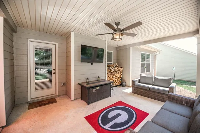 a living room with furniture and a flat screen tv