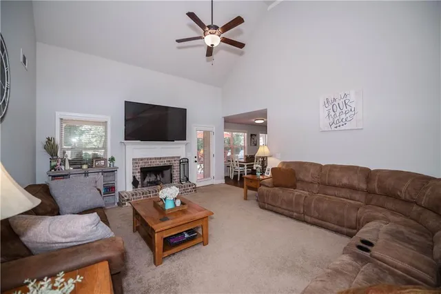 a living room with furniture fireplace and a flat screen tv