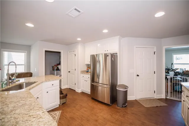 a kitchen with stainless steel appliances a refrigerator sink and cabinets