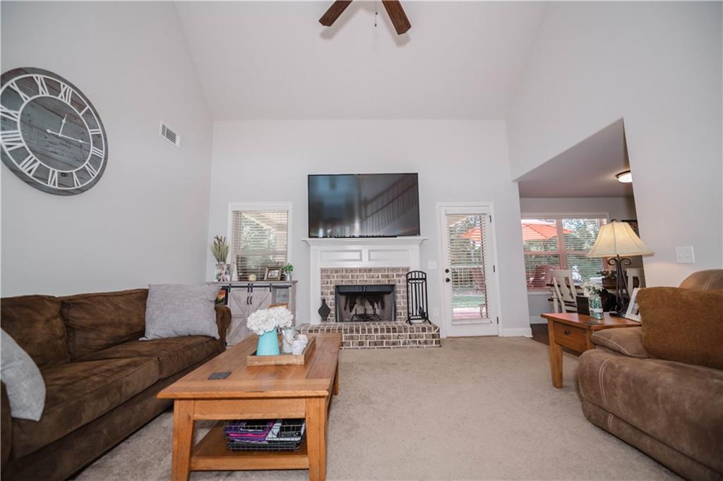 117 Kensington Trace Bethlehem, GA 30620 - Photo 7 of 43 a living room with furniture a flat screen tv and a fireplace