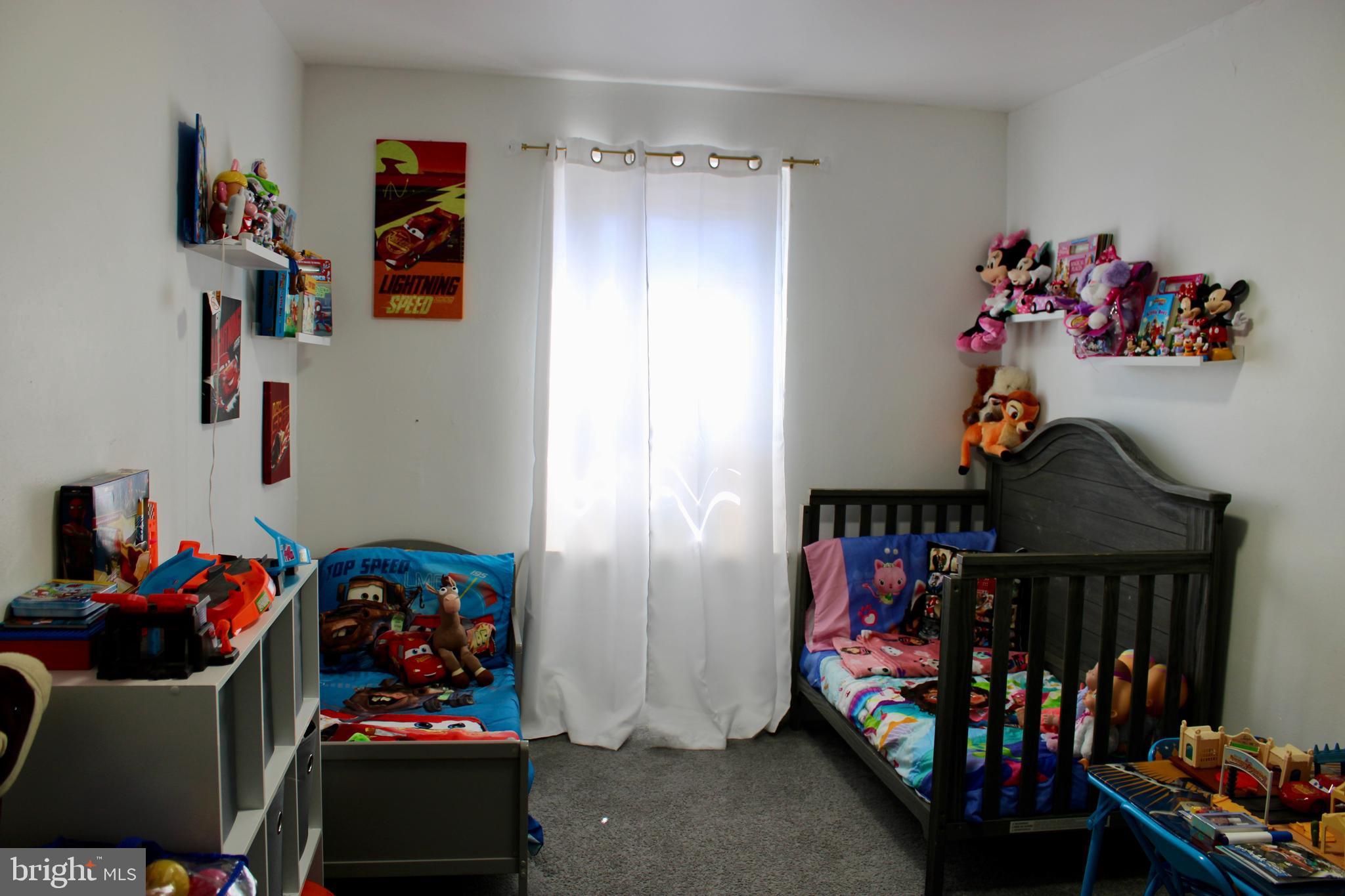 1211 South Octagon Road Camden, NJ 08104 - Photo 11 of 18 a bedroom with lots of baby toys and wooden floor