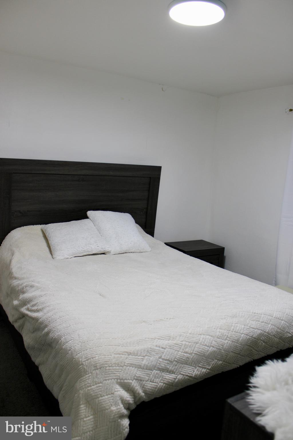 1211 South Octagon Road Camden, NJ 08104 - Photo 12 of 18 a bedroom with a bed and a night stand
