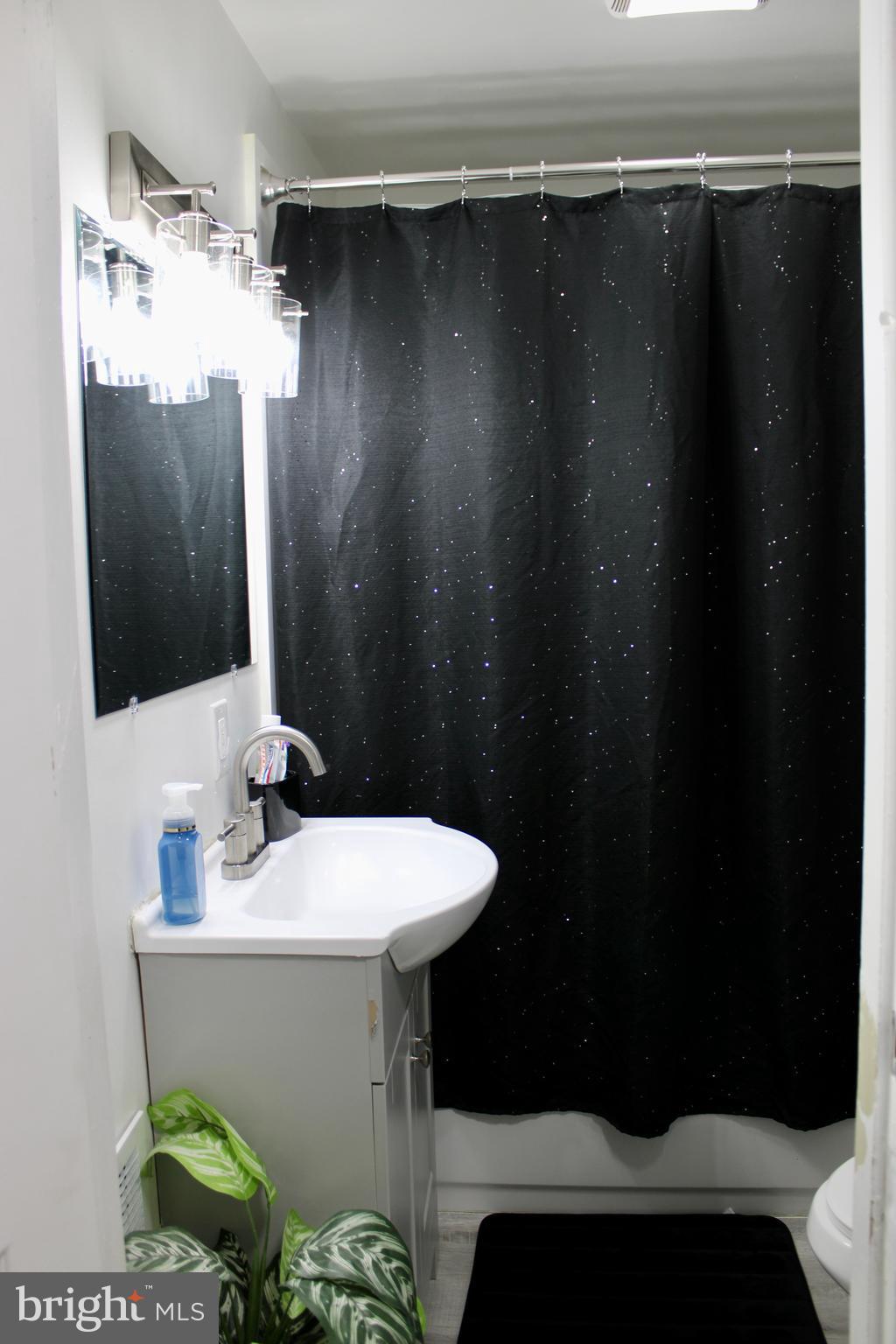 1211 South Octagon Road Camden, NJ 08104 - Photo 8 of 18 a bathroom with a sink and mirror