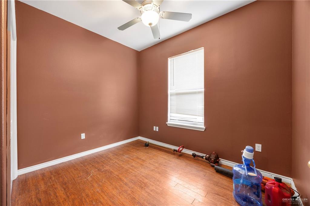 232 Nannette Avenue Pharr, TX 78577 - Photo 9 of 13 a view of a room with a window and wooden floor
