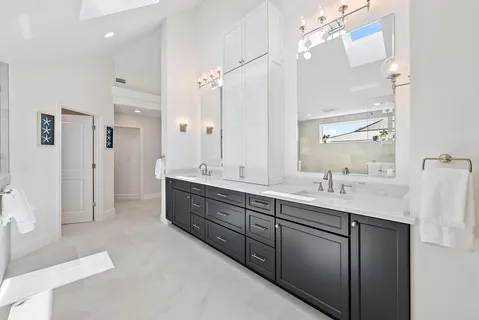 a bathroom with a double vanity sink a mirror and a shower