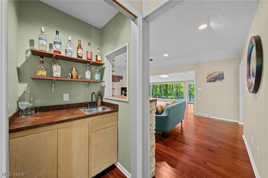 4830 Som Center Road Moreland Hills, OH 44022 - Photo 9 of 48 A hidden gem off the living room: a stylish wet bar tucked discreetly out of sight, ready to be revealed for effortless entertaining whenever the moment calls.