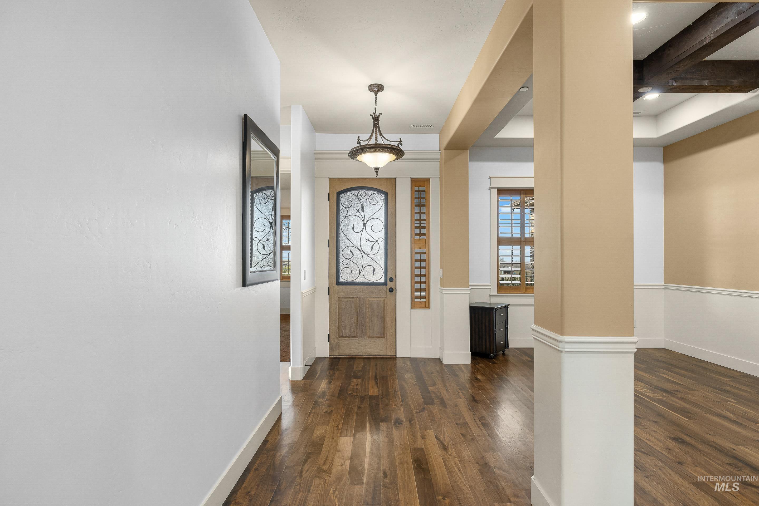 7521 North Grand Ridge Lane Eagle, ID 83616 - Photo 7 of 50 Foyer with dark wood-type flooring and beam ceiling
