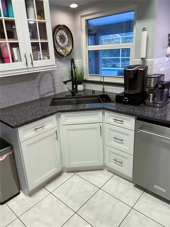2571 Running Oak Court Spring Hill, FL 34608 - Photo 11 of 37 a kitchen with stainless steel appliances granite countertop a sink and cabinets