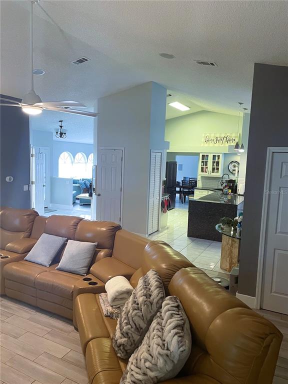 2571 Running Oak Court Spring Hill, FL 34608 - Photo 16 of 37 a living room with furniture and a fireplace