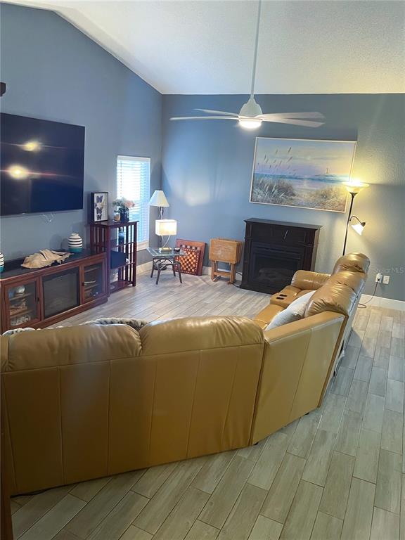 2571 Running Oak Court Spring Hill, FL 34608 - Photo 17 of 37 a living room with furniture and a fireplace