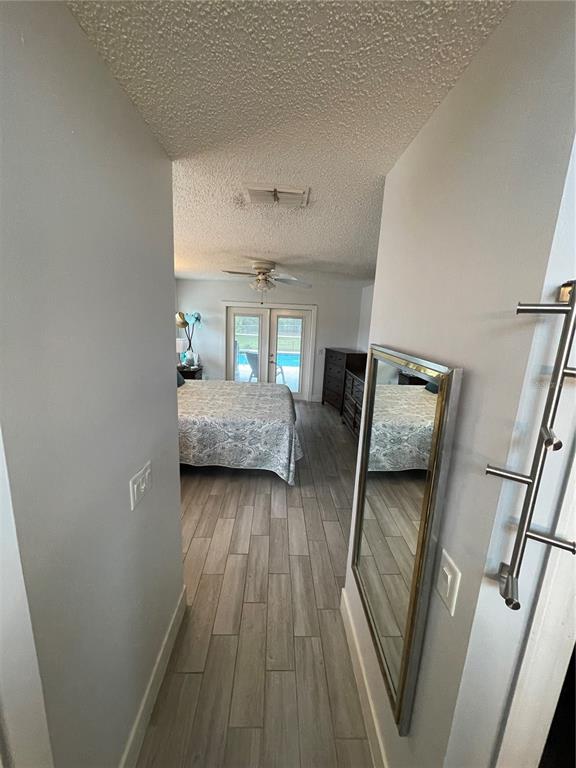 2571 Running Oak Court Spring Hill, FL 34608 - Photo 22 of 37 a bedroom with a bed and wooden floor