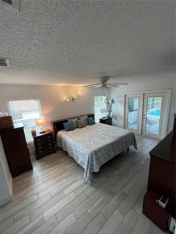 2571 Running Oak Court Spring Hill, FL 34608 - Photo 23 of 37 a bedroom with a bed and wooden floor