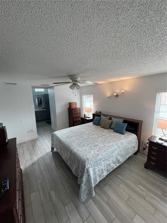 2571 Running Oak Court Spring Hill, FL 34608 - Photo 25 of 37 a bedroom with a bed and wooden floor