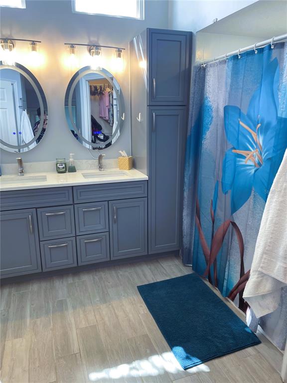 2571 Running Oak Court Spring Hill, FL 34608 - Photo 26 of 37 a bathroom with a double vanity sink and a mirror