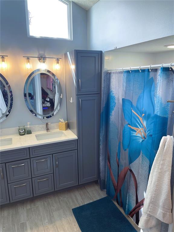 2571 Running Oak Court Spring Hill, FL 34608 - Photo 28 of 37 a bathroom with a double vanity sink and a mirror