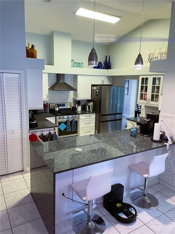 2571 Running Oak Court Spring Hill, FL 34608 - Photo 6 of 37 a kitchen with stainless steel appliances granite countertop a stove and a sink