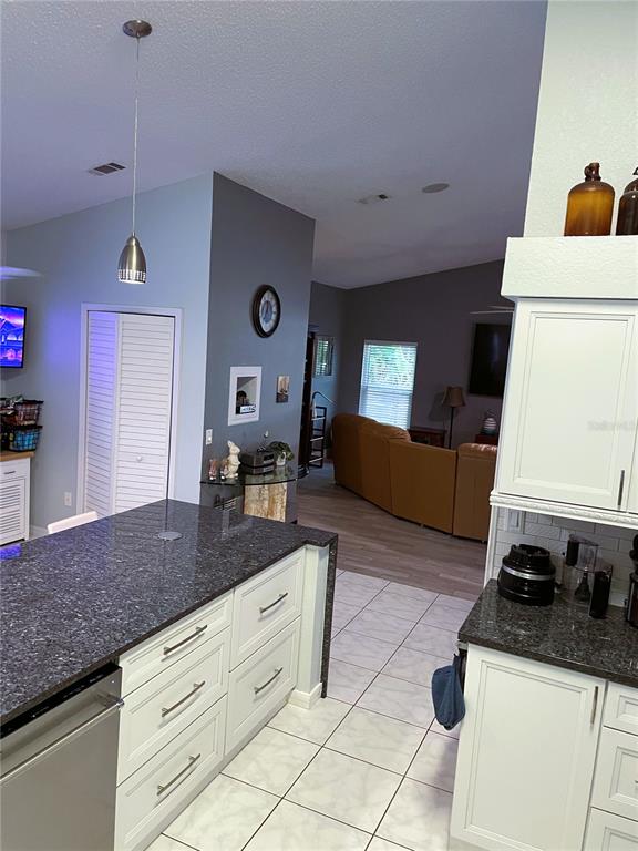 2571 Running Oak Court Spring Hill, FL 34608 - Photo 8 of 37 a kitchen with stainless steel appliances granite countertop a sink stove and cabinets