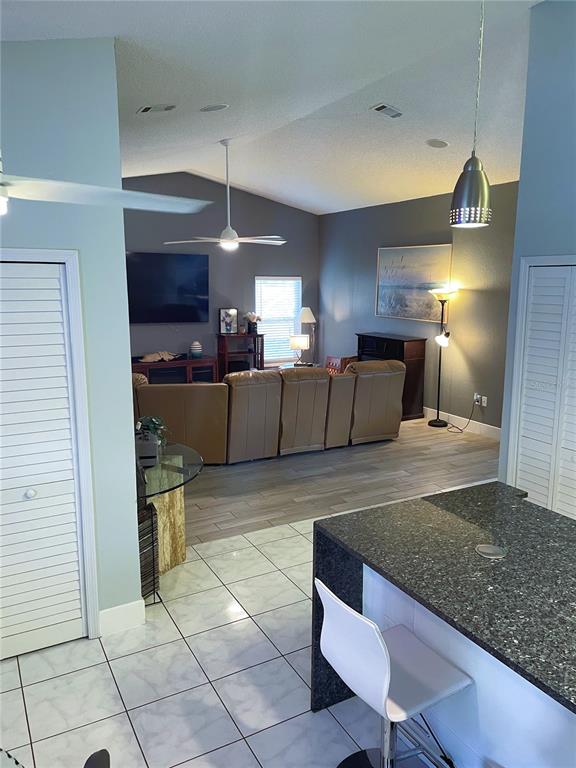 2571 Running Oak Court Spring Hill, FL 34608 - Photo 9 of 37 a kitchen with stainless steel appliances kitchen island granite countertop a sink and cabinets