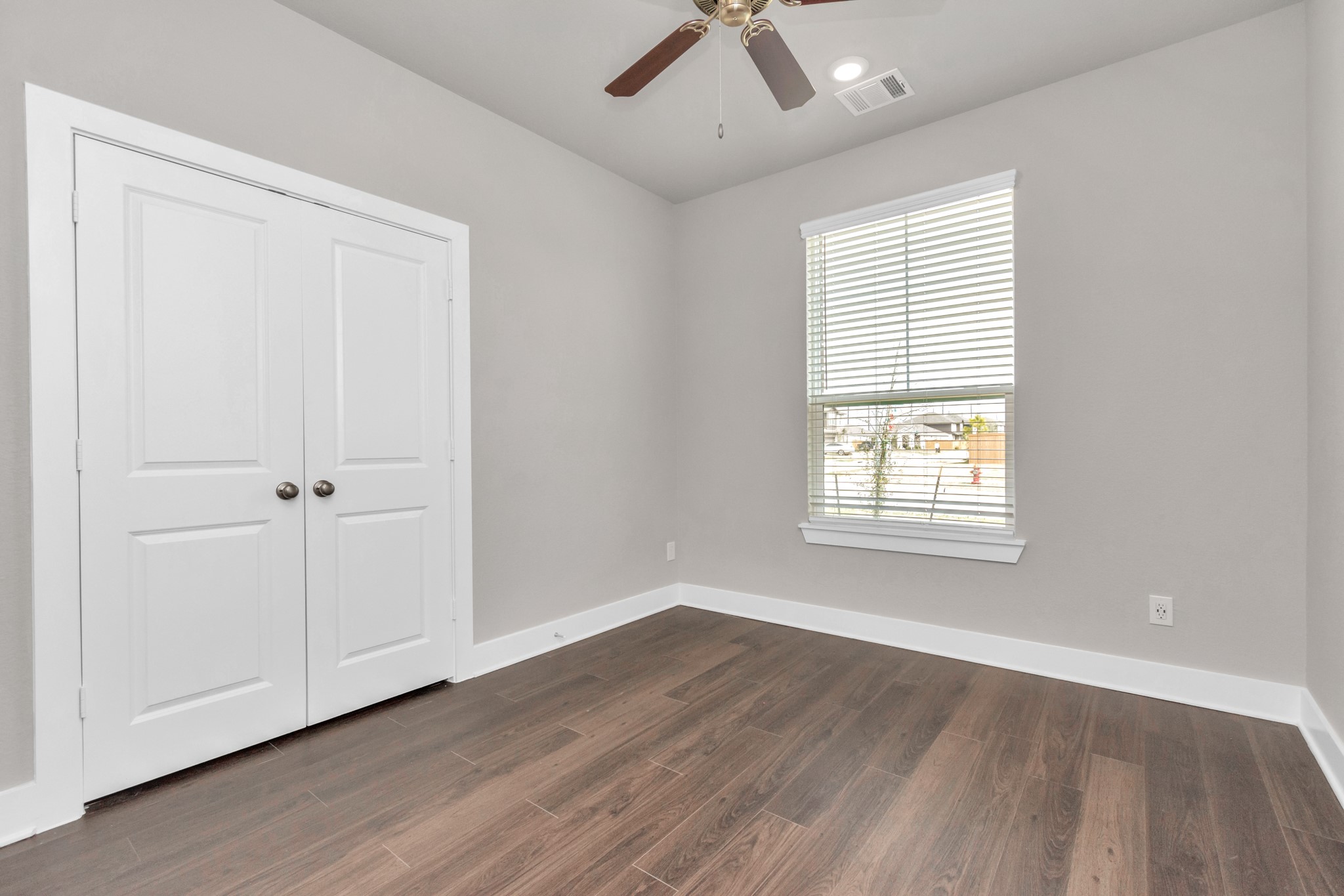 10519 Moon Valley Lane Rosharon, TX 77583 - Photo 12 of 23 a view of an empty room with a window and wooden floor