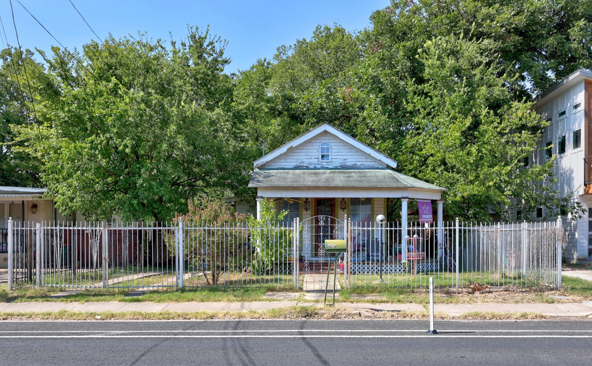2907 East 5th Street Austin, TX 78702 - Photo 12 of 22 a view of a house with a small yard plants and large tree