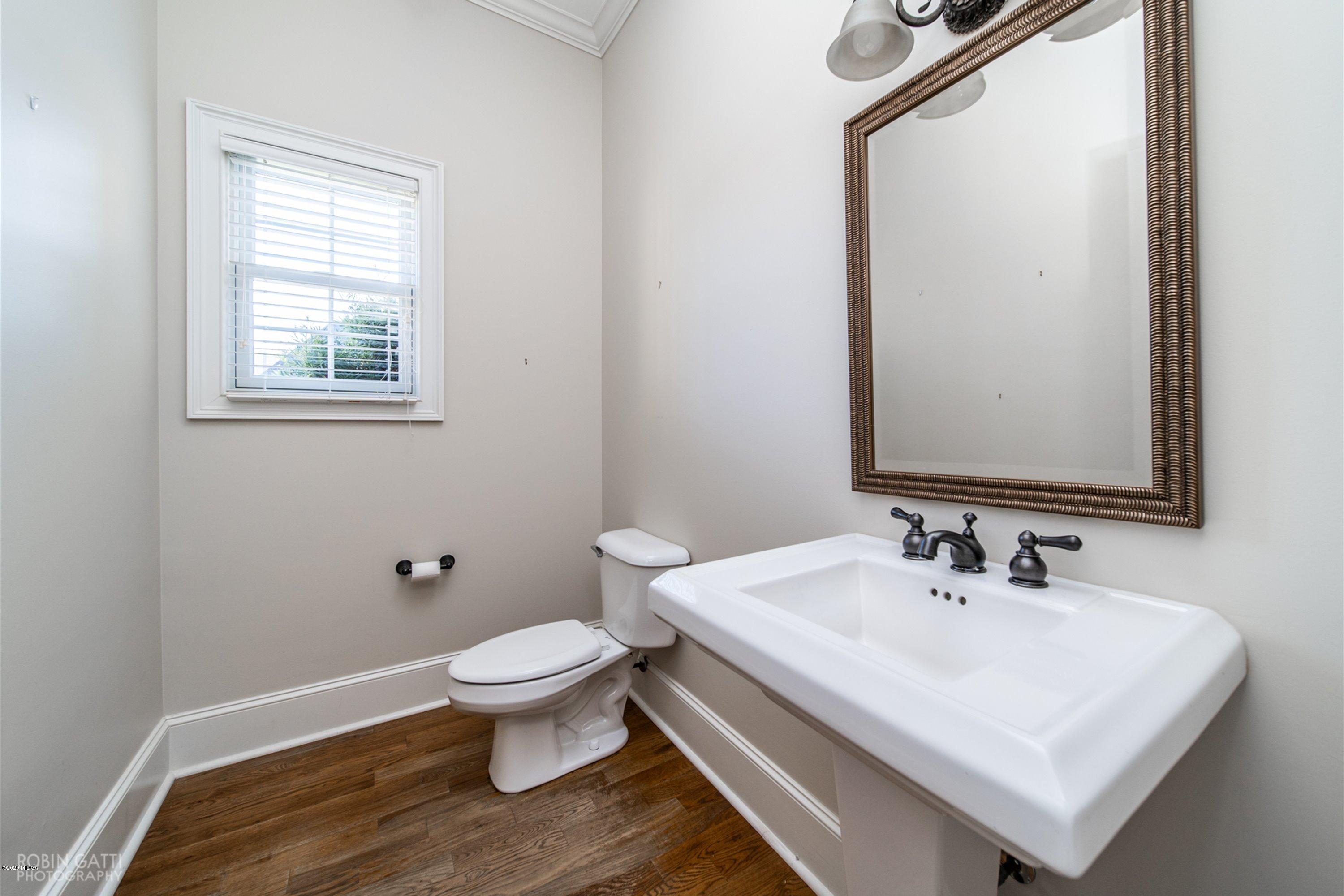 5022 Tucker Ridge Macon, GA 31210 - Photo 12 of 38 a white toilet sitting next to a bathroom sink