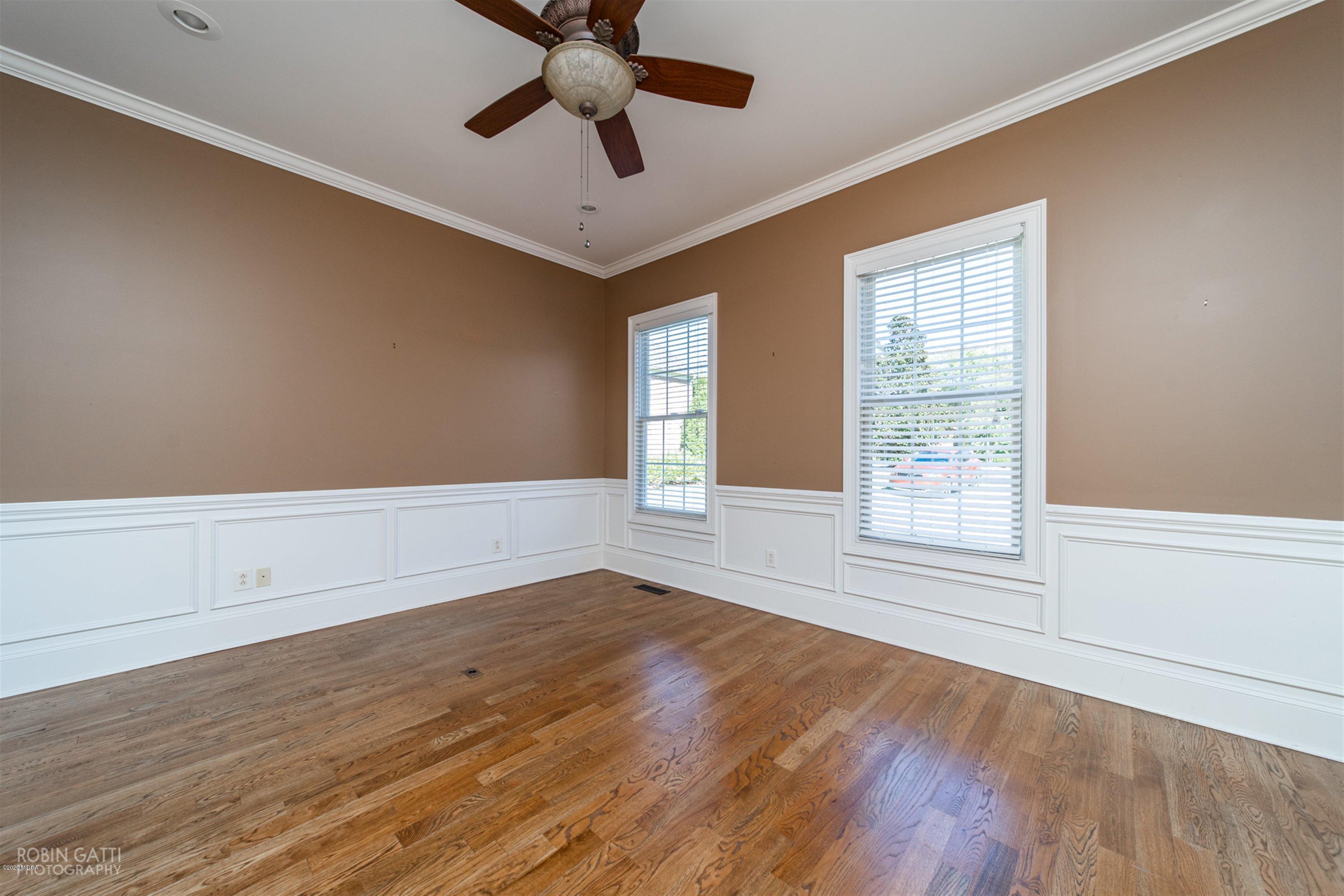 5022 Tucker Ridge Macon, GA 31210 - Photo 15 of 38 an empty room with wooden floor chandelier fan and windows