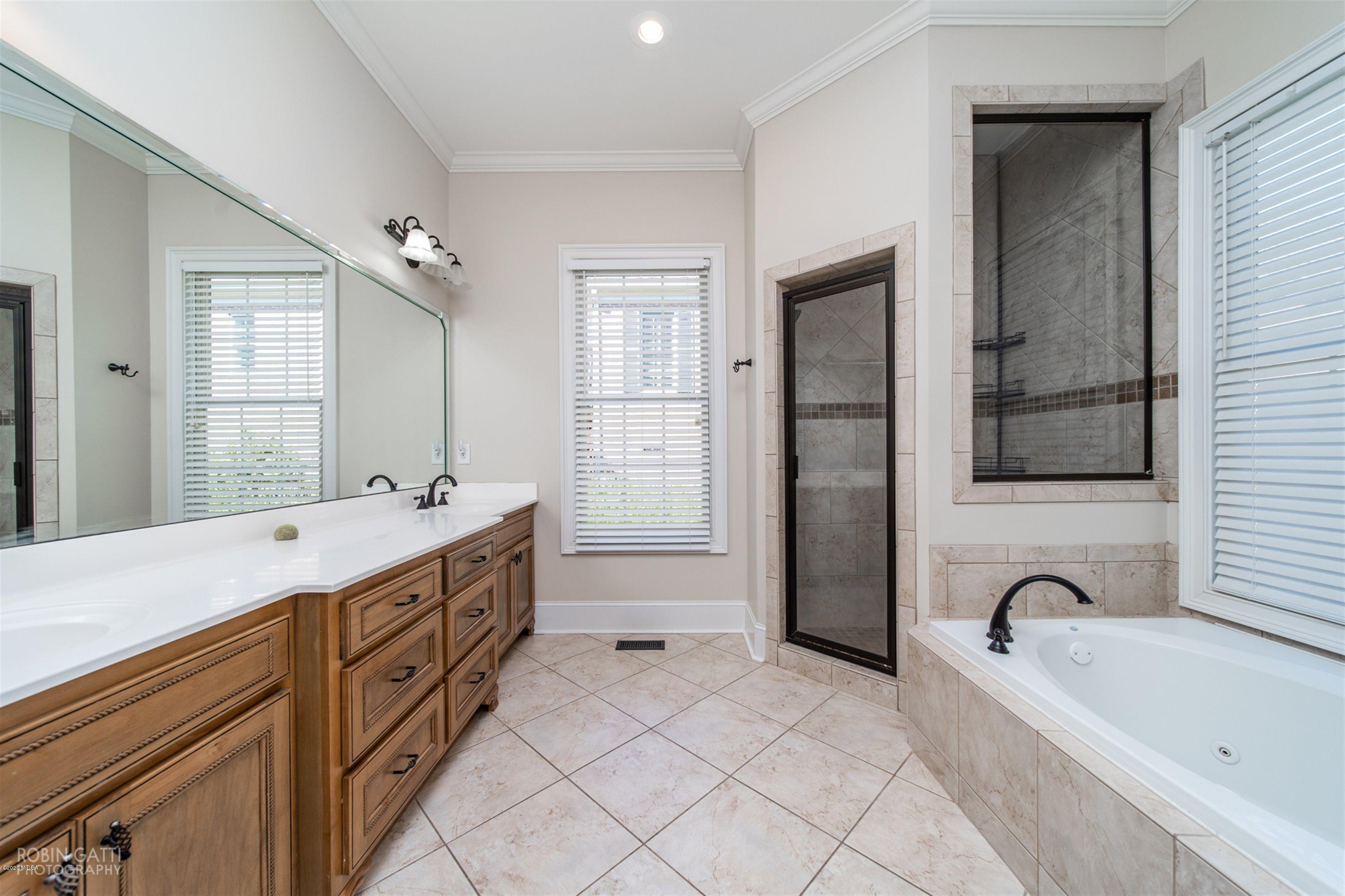 5022 Tucker Ridge Macon, GA 31210 - Photo 17 of 38 a spacious bathroom with a bathtub sink and mirror
