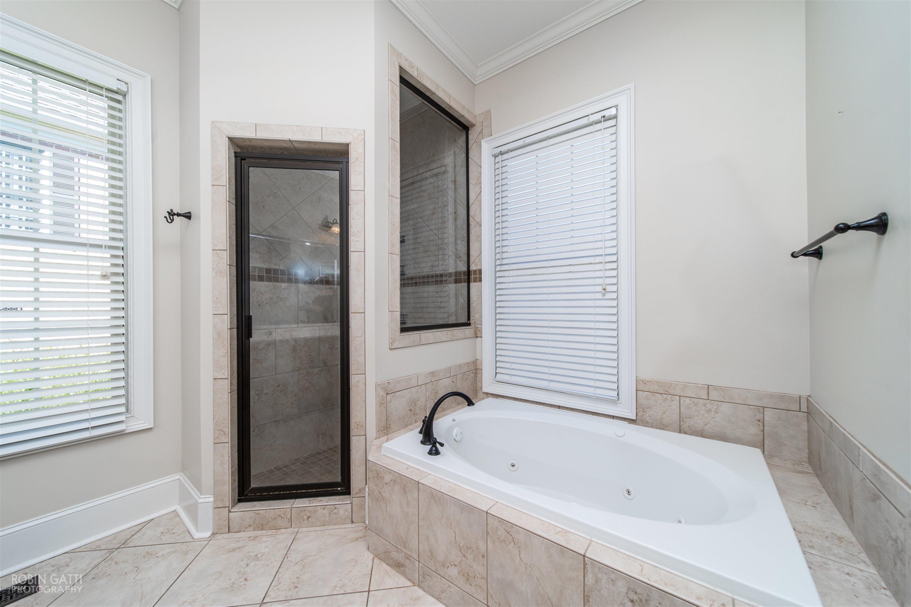 5022 Tucker Ridge Macon, GA 31210 - Photo 18 of 38 a bathroom with a bathtub and shower