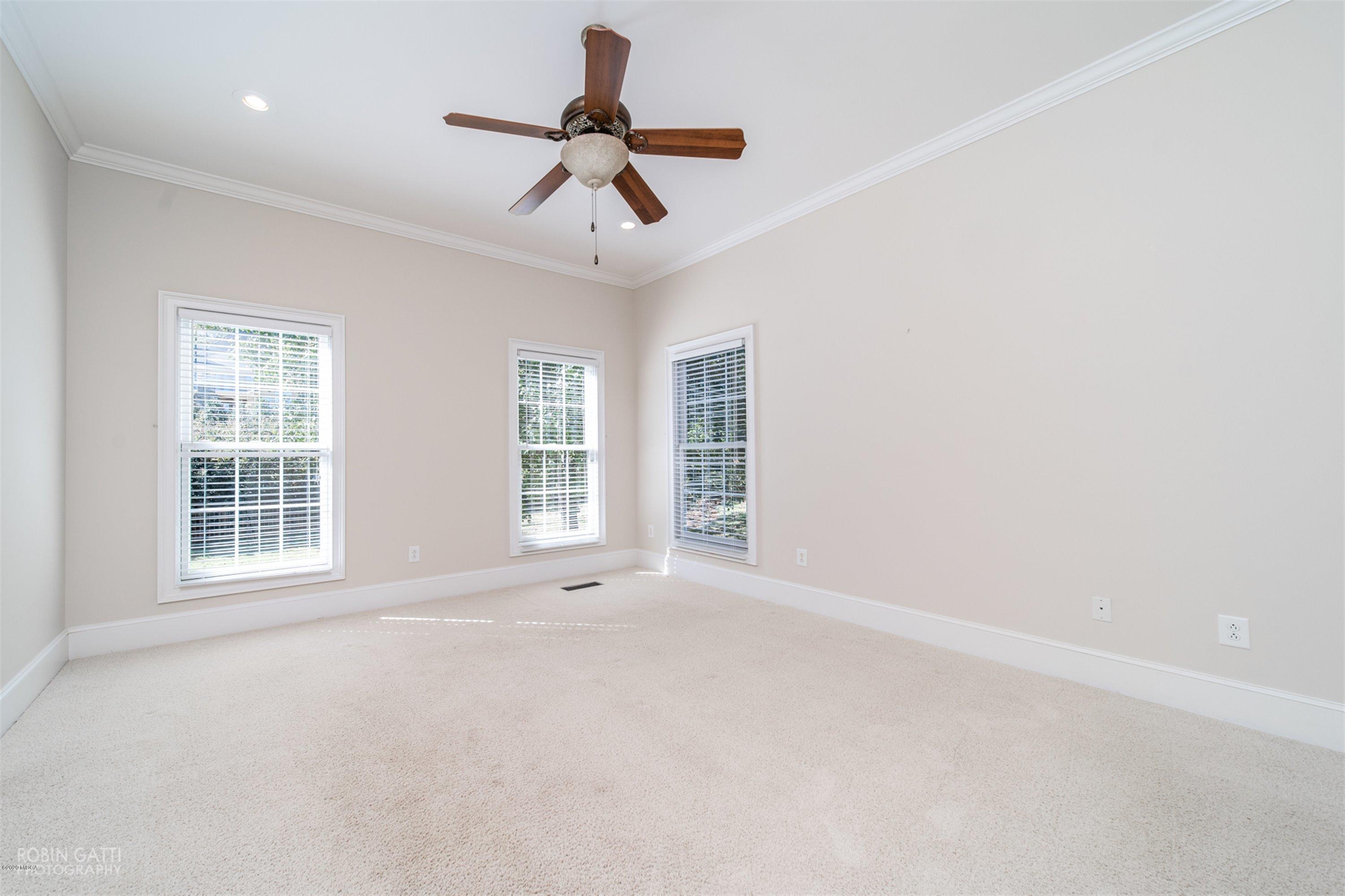 5022 Tucker Ridge Macon, GA 31210 - Photo 19 of 38 an empty room with windows and ceiling fan