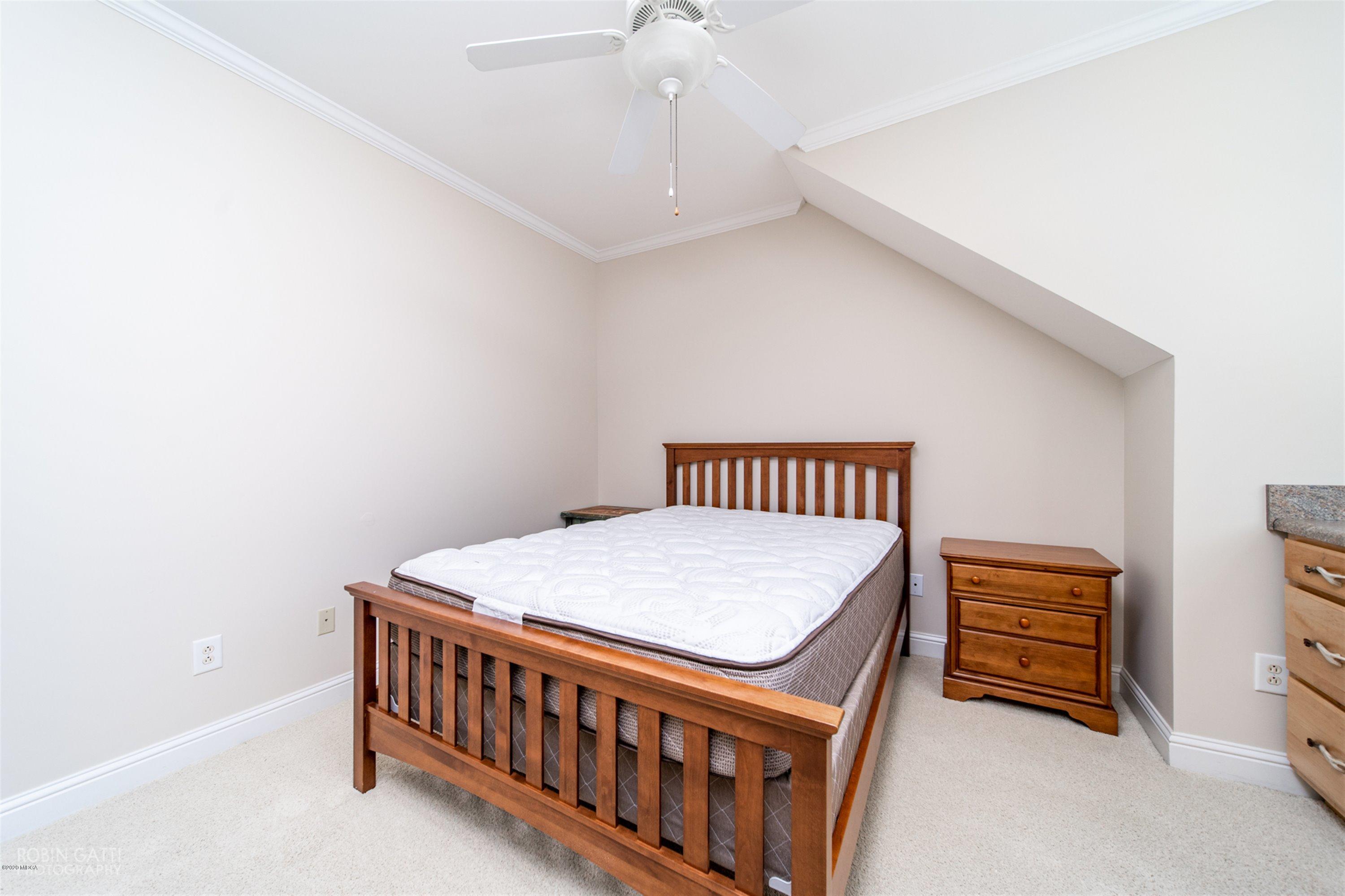 5022 Tucker Ridge Macon, GA 31210 - Photo 25 of 38 a bedroom with a bed and a chandelier