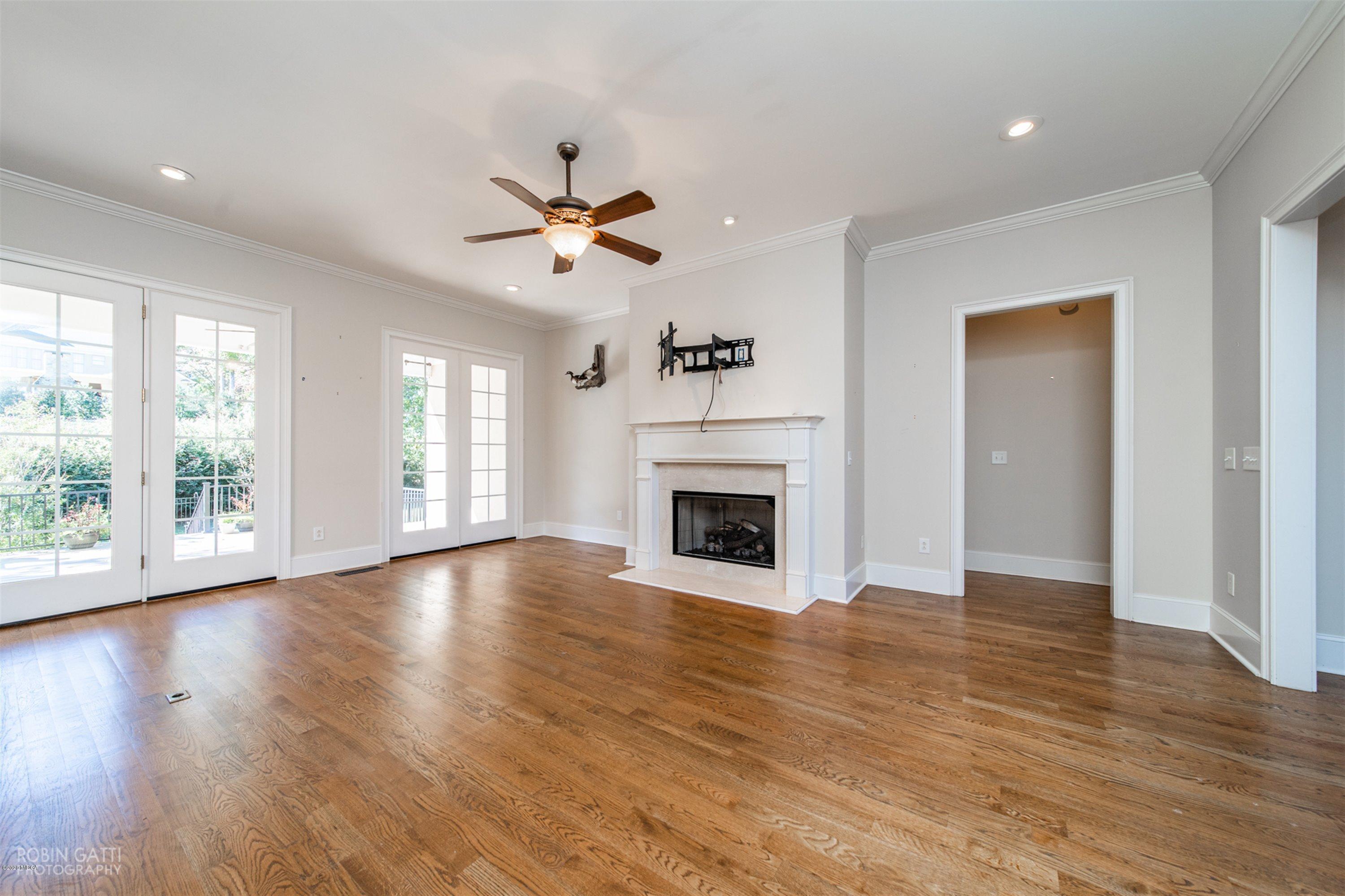 5022 Tucker Ridge Macon, GA 31210 - Photo 5 of 38 a view of a livingroom with a fireplace a ceiling fan and windows