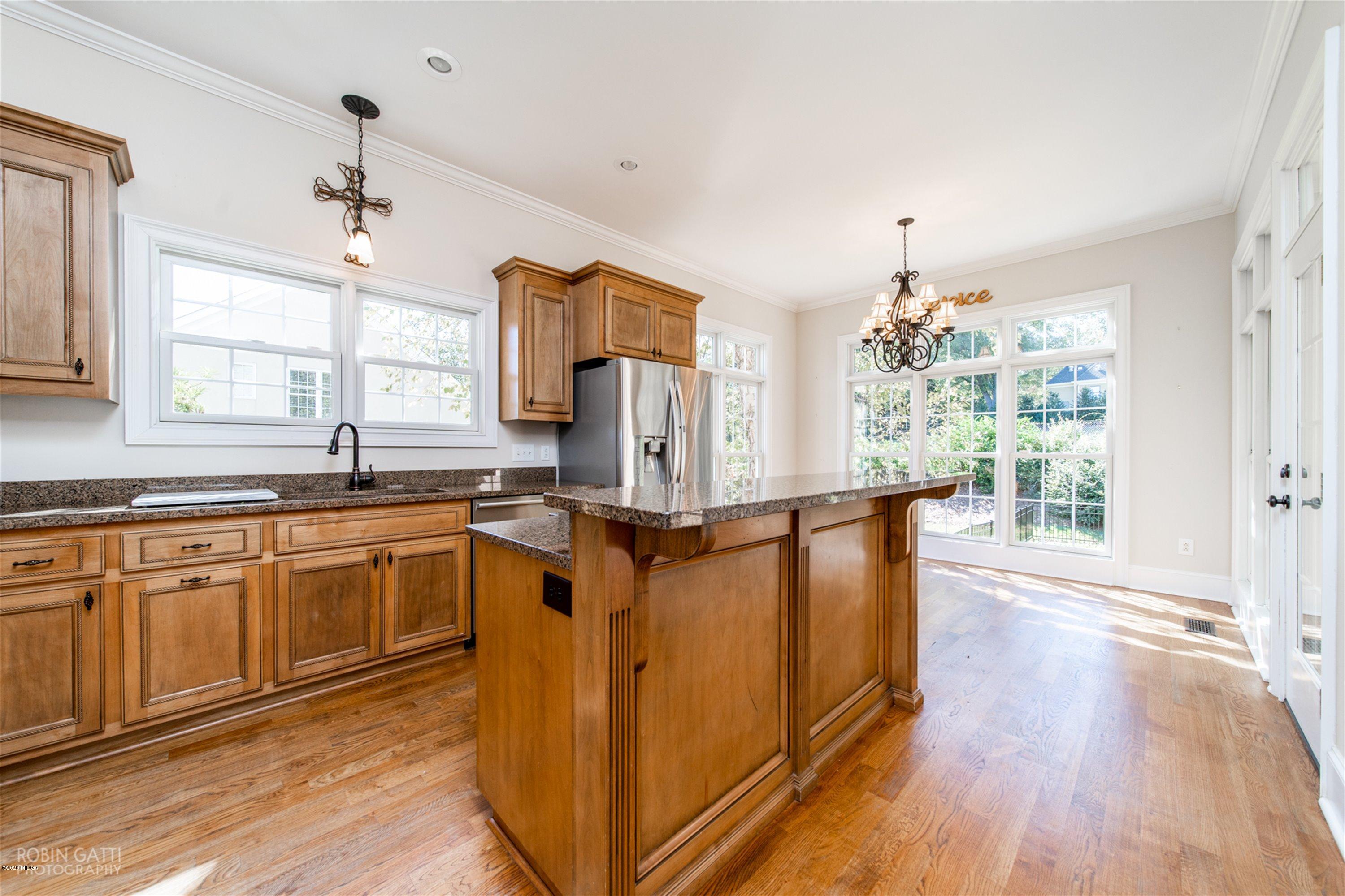 5022 Tucker Ridge Macon, GA 31210 - Photo 6 of 38 a kitchen with stainless steel appliances granite countertop a refrigerator a sink dishwasher a stove and white countertops with wooden floor