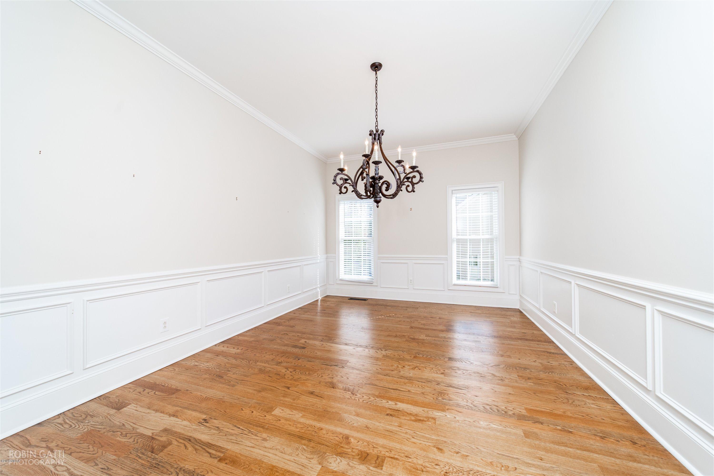 5022 Tucker Ridge Macon, GA 31210 - Photo 10 of 38 a view of an empty room with chandelier and wooden floor
