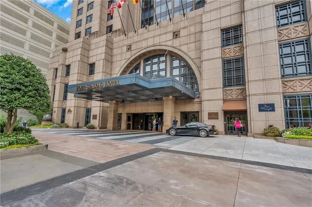 a view of a building with car parked