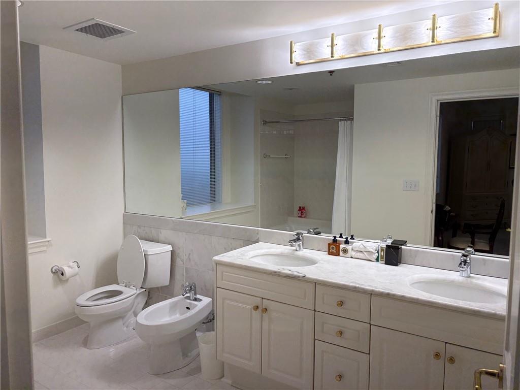 75 14th Street Northeast, Unit 3650 Atlanta, GA 30309 - Photo 17 of 25 a bathroom with a double vanity sink toilet and mirror