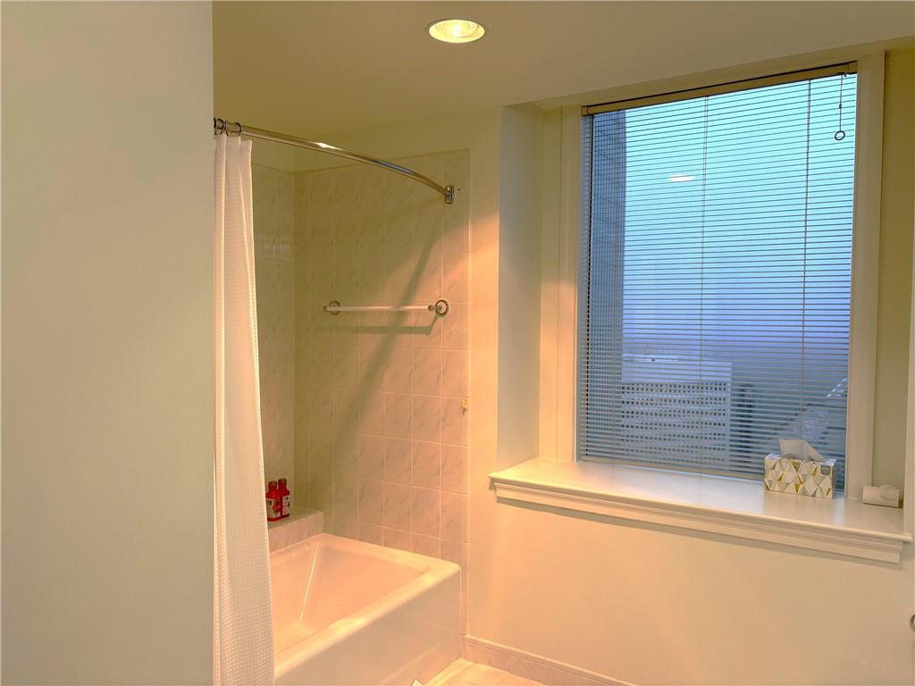 75 14th Street Northeast, Unit 3650 Atlanta, GA 30309 - Photo 18 of 25 a bathroom with a shower and a tub