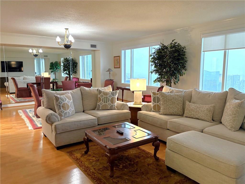 75 14th Street Northeast, Unit 3650 Atlanta, GA 30309 - Photo 6 of 25 a living room with furniture and a large window