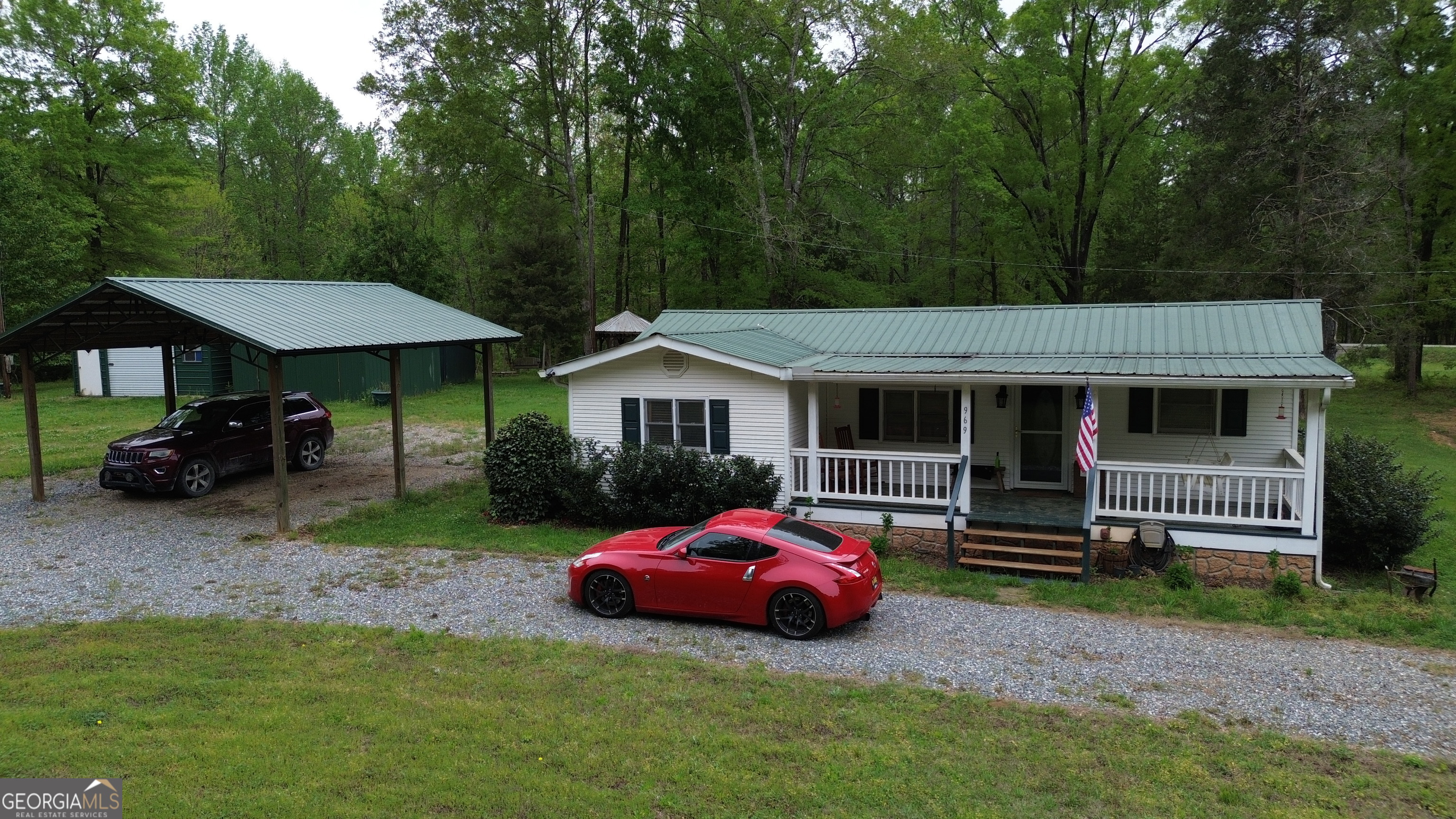 969 Flowers Road Molena, GA 30258 - Photo 3 of 16 a front view of a house with a garden and trees